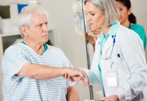 older male being assisted by a doctor